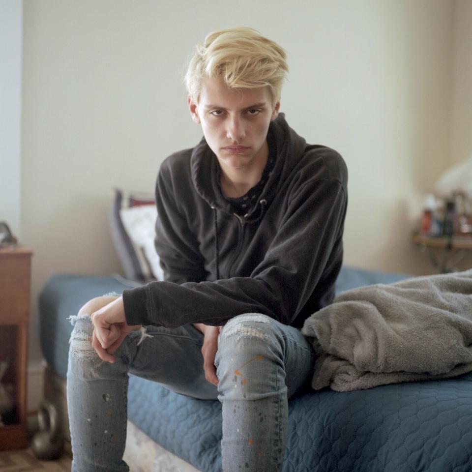 Peter Herridge, 16, poses for a portrait in his home.