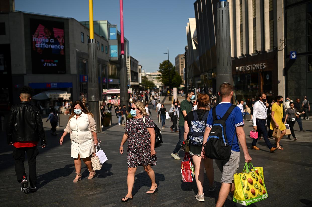 Pedestrians, some wearing a face mask or covering due to the COVID-19 pandemic, walk along a busy shopping street in Birmingham, central England on September 14, 2020 after the British government imposed fresh restrictions on the city after an rise in cases of the novel coronavirus. - Authorities in Britain's second city of Birmingham announced new coronavirus restrictions Friday as the nation's viral reproduction rate, or R number, exceeded 1.0 for the first time since March. (Photo by Oli SCARFF / AFP) (Photo by OLI SCARFF/AFP via Getty Images)