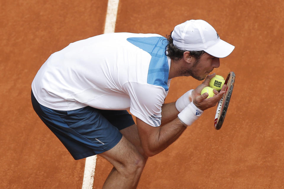 Juan Monaco from Argentina discusses a point with umpire Carlos Bernardes during a Madrid Open tennis tournament match against Rafael Nadal from Spain in Madrid, Spain, Wednesday, May 7, 2014. (AP Photo/Andres Kudacki)