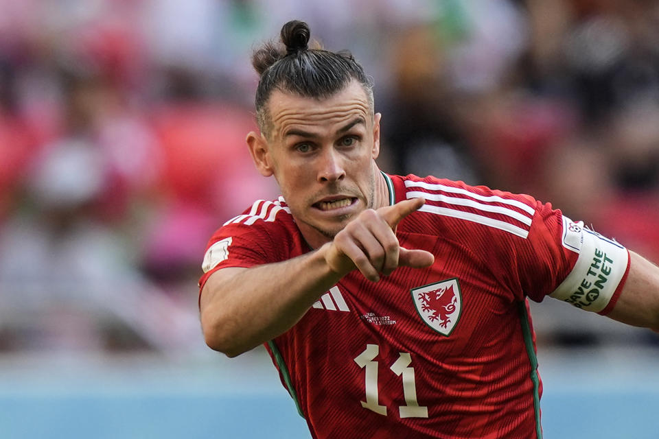 Wales' Gareth Bale wears an armband reading "save the planet" during the World Cup group B soccer match between Wales and Iran, at the Ahmad Bin Ali Stadium in Al Rayyan , Qatar, Friday, Nov. 25, 2022. (AP Photo/Frank Augstein)