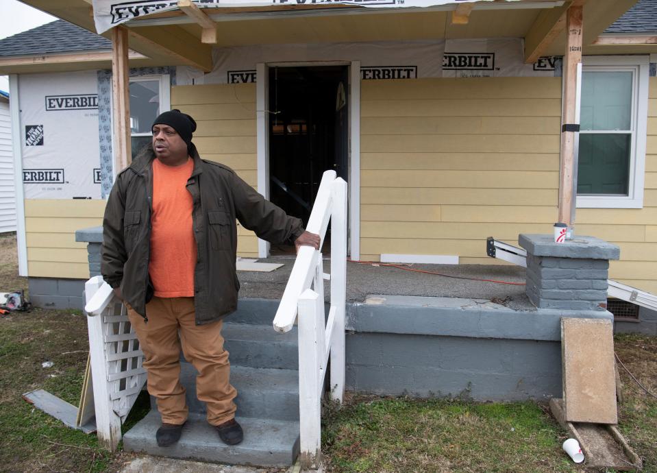 Daniel McDaniel stands outside his home after bringing lunch to members of Hope Force International, a charity organization, who are repairing his tornado damaged home Friday, Feb. 12, 2021 in Nashville, Tenn. McDaniel was uninsured when a tornado ripped through the neighborhood in March 2020.