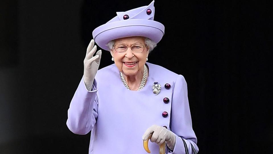 Queen Elizabeth II waves as she attends an Armed Forces Act of Loyalty Parade at the Palace of Holyroodhouse