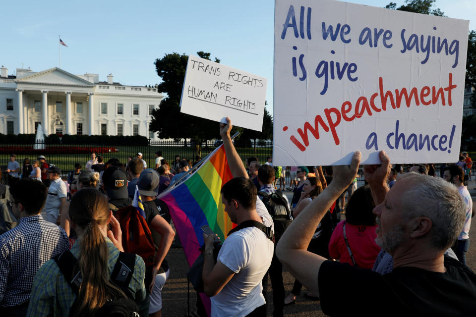 Demonstrators gather to protest U.S. President Donald Trump's announcement that he plans to reinstate a ban on transgender individuals from serving in any capacity in the U.S. military, at the White House in Washington, U.S. July 26, 2017. REUTERS/Jonathan Ernst