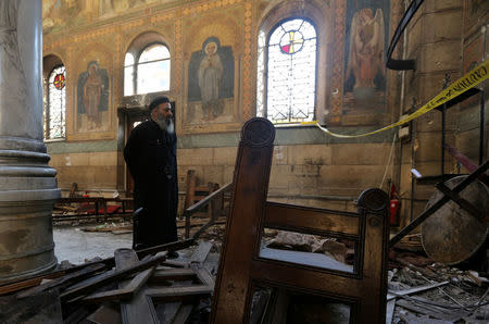 FILE PHOTO: A Coptic priest stands at the scene following a bombing inside Cairo's Coptic cathedral in Egypt December 11, 2016. To match Analysis EGYPT-SECURITY/ REUTERS/Mohamed Abd El Ghany/File photo