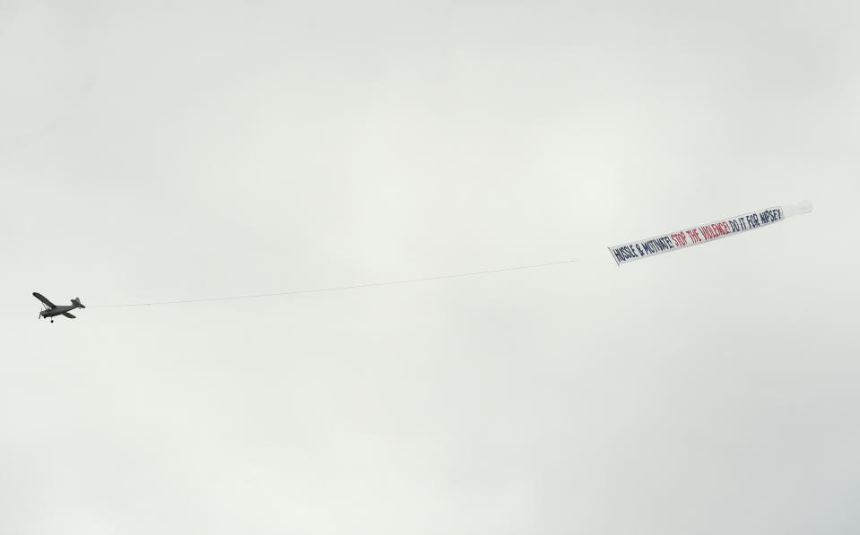 A plane carrying a banner reading "Hussle & Motivate, Stop the Violence, Do it for Nipsey" flies overhead at the Celebration of Life memorial service for late rapper Nipsey Hussle, whose given name was Ermias Asghedom, on Thursday, April 11, 2019, at the Staples Center in Los Angeles. (Photo by Chris Pizzello/Invision/AP)