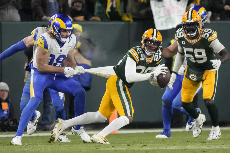 Los Angeles Rams wide receiver Ben Skowronek (18) tries to tackle Green Bay Packers cornerback Rasul Douglas (29) after an interception in the second half of an NFL football game in Green Bay, Wis. Monday, Dec. 19, 2022. (AP Photo/Morry Gash)