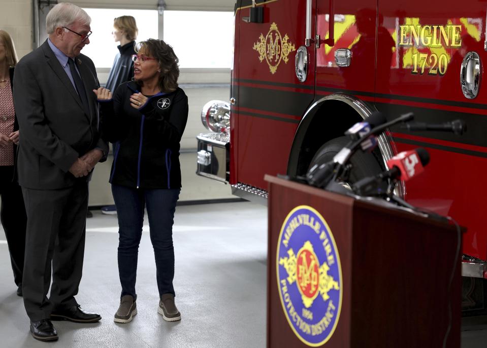 Missouri Rep. Jim Murphy, left, speaks with Monica Kelsey, founder of the Safe Haven Baby Box, right, before a news conference on Monday, Feb. 12, 2024, at the Mehlville Fire District Station 2 in south St. Louis County, Mo. A newborn baby is healthy and in state custody after being left in the station's box on Thursday, Feb. 8. (Christine Tannous/St. Louis Post-Dispatch via AP)