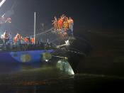 Rescue workers are seen atop a sunken ship in the Jianli section of Yangtze River, Hubei province, China, June 2, 2015. Rescuers fought bad weather on Tuesday as they searched for more than 400 people, many of them elderly Chinese tourists, missing after a cruise boat was buffeted by a freak tornado and capsized on the Yangtze River. (REUTERS/Kim Kyung-Hoon)