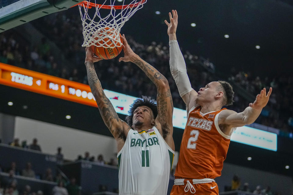 Baylor's Jalen Bridges (11) goes up for a basket against Texas's Chendall Weaver (2) during the first half of an NCAA college basketball game, Monday, March 4, 2024, in Waco, Texas. (AP Photo/Julio Cortez)