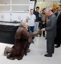 WELLINGTON, NEW ZEALAND - NOVEMBER 14: Prince Charles, Prince of Wales is handed a birthday card as he meets Mark Hadlow who plays Dori in the new 'Hobbit' film at Weta Workshop on November 14, 2012 in Wellington, New Zealand. The Royal couple are in New Zealand on the last leg of a Diamond Jubilee that takes in Papua New Guinea, Australia and New Zealand. (Photo by Chris Jackson/Getty Images)