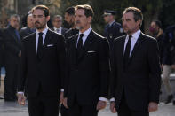 CORRECTS THE NAME OF PRINCE ON THE RIGHT Prince Philippos, left, Prince Pavlos, center, and Prince Nikolaos right, sons of former king of Greece Constantine II stand behind their father coffin as they arrive at the Metropolitan cathedral for his funeral in Athens, Monday, Jan. 16, 2023. Constantine died in a hospital late Tuesday at the age of 82 as Greece's monarchy was definitively abolished in a referendum in December 1974. (AP Photo/Petros Giannakouris)