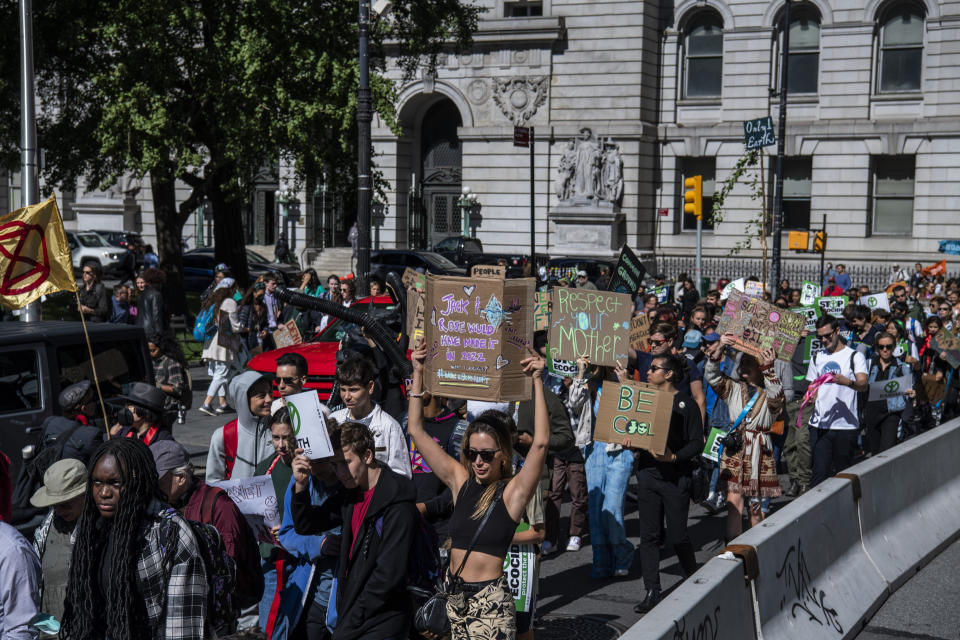 Activists gather and walk through lower Manhattan for the Global Climate Strike protests, Friday, Sept. 23, 2022, in New York. (AP Photo/Brittainy Newman)