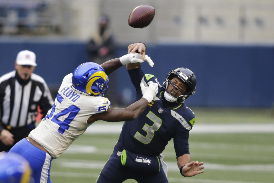 Los Angeles Rams outside linebacker Leonard Floyd (54) knocks the ball away as Seattle Seahawks quarterback Russell Wilson tries to pass during the first half of an NFL wild-card playoff football game, Saturday, Jan. 9, 2021, in Seattle. (AP Photo/Scott Eklund)