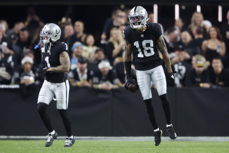 Las Vegas Raiders cornerback Jack Jones (18) celebrates after running back an interception for a touchdown against the Los Angeles Chargers during the second half of an NFL football game, Thursday, Dec. 14, 2023, in Las Vegas. (AP Photo/Steve Marcus)