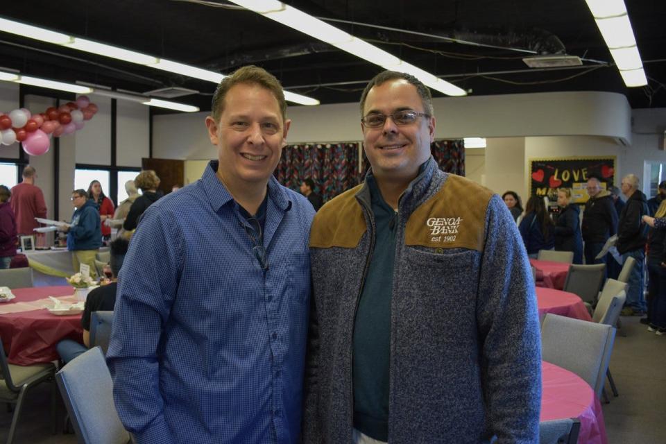 Senior Pastor Fred Garcia and Brian Huston take a break from the desserts at the Chocolate Lovers’ Fest at Apostolic Restoration Center in Genoa.