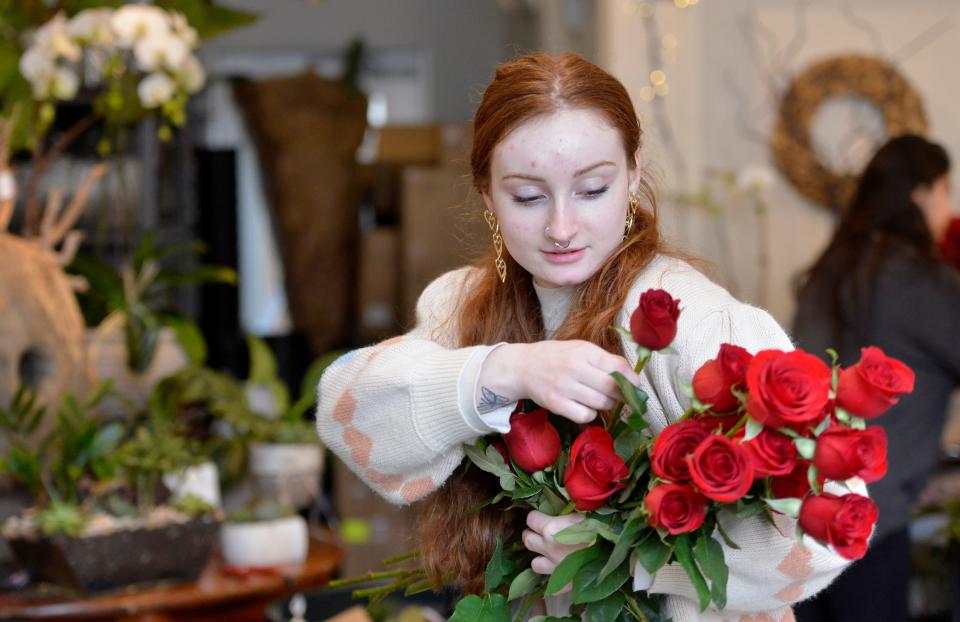 Darcey McMahon selected roses for an arrangement she was making at Verde Floral Design in Mashpee Commons for last year's Valentine's Day.