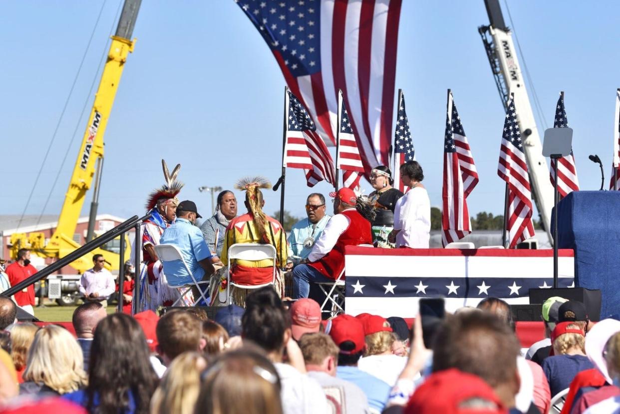 Members of a Lumbee Tribe drum circle perform on stage ahead of President Donald Trump's speech Saturday, Oct. 24, 2020, at the Robeson County Fairgrounds in Lumberton.