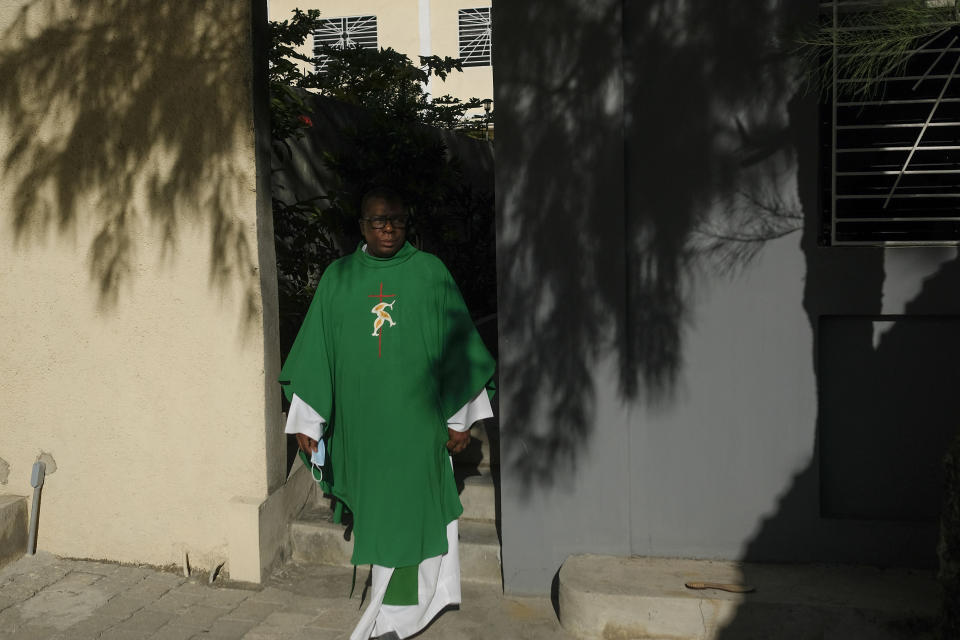 FILE - Catholic priest Jean-Nicaisse Milien walks to give a Mass in Port-au-Prince, Haiti, Nov. 7, 2021. Father Milien was kidnapped for 20 days along with other priests, nuns, and civilians in April by the 400 Mawozo gang who have been holding 17 members of a U.S.-based missionary group Christian Aid Ministries for more than 3 weeks. (AP Photo/Matias Delacroix, File)