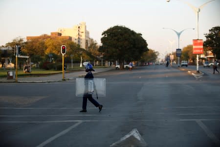 A riot police officer patrols the streets in Bulawayo