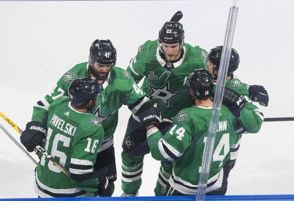 Dallas Stars center Joe Pavelski (16) celebrates his goal against the Tampa Bay Lightning with teammates during the first period of Game 4 of the NHL hockey Stanley Cup Final, Friday, Sept. 25, 2020, in Edmonton, Alberta. (Jason Franson/The Canadian Press via AP)