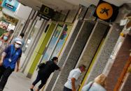 People walk past branches of Bankia and Caixabank in Barcelona