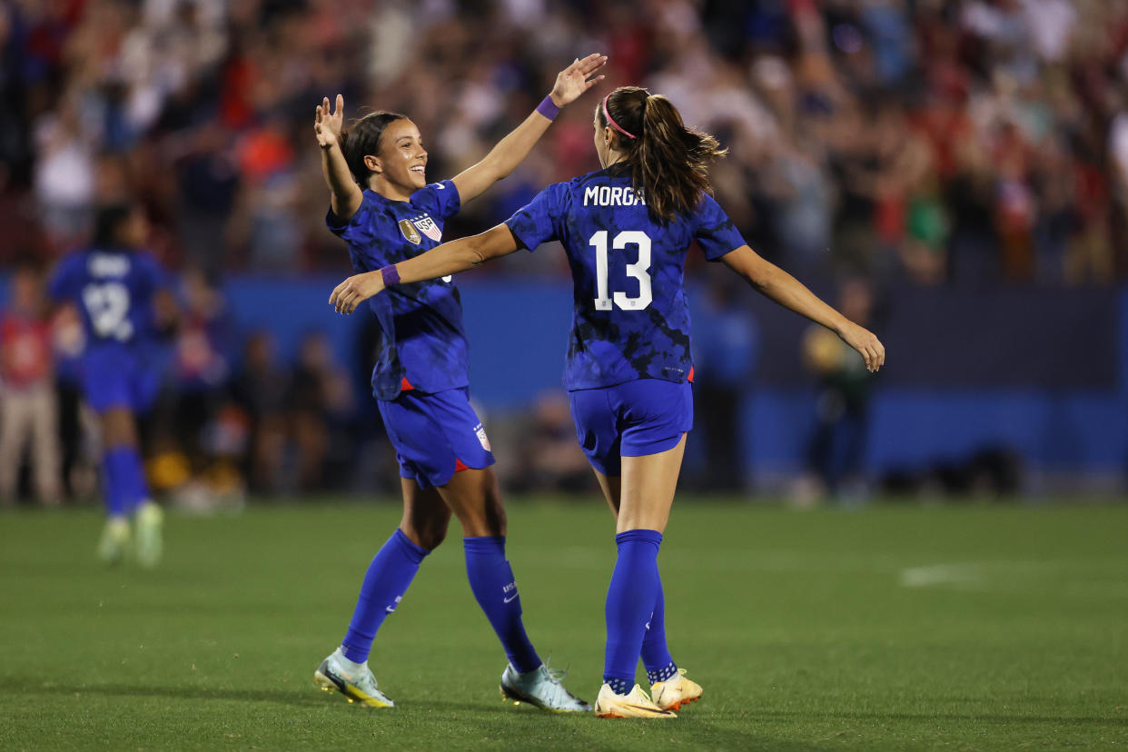 FRISCO, TX - FEBRUARY 22: Alex Morgan #13 of United States celebrates with teammate Mallory Swanson #9 after scoring the team's first goal during a 2023 SheBelieves Cup match between United States and Brazil at Toyota Stadium on February 22, 2023 in Frisco, Texas. (Photo by Omar Vega/Getty Images)