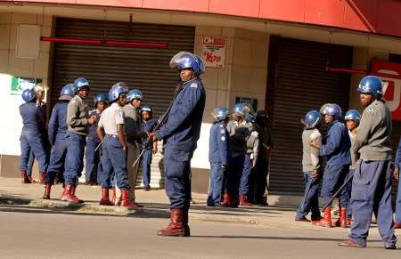 Riot police patrol the streets after police earlier banned planned protests by the opposition party Movement for Democratic Change (MDC) in Harare