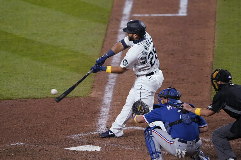 Seattle Mariners' Jose Marmolejos hits a single to score Kyle Seager during the eighth inning of the team's baseball game against the Texas Rangers, Saturday, Sept. 5, 2020, in Seattle. (AP Photo/Ted S. Warren)