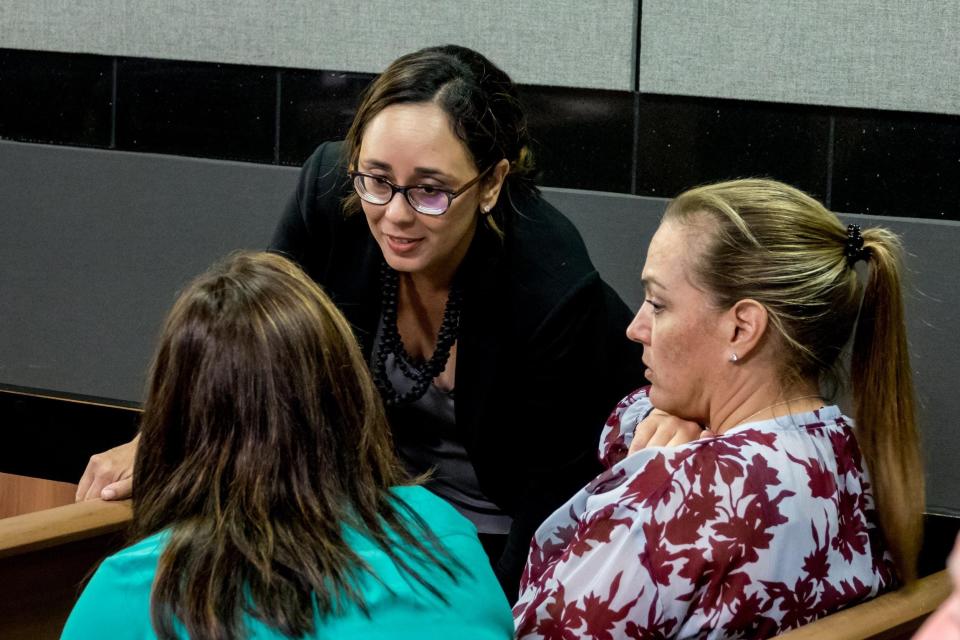 Attorney Lynn Gelin (center).