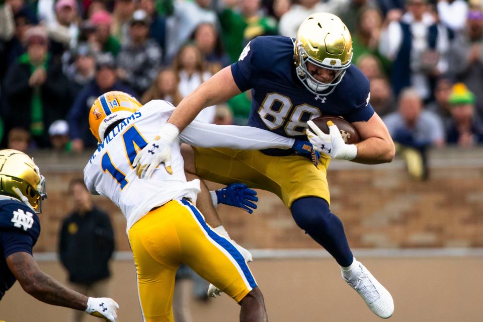 Notre Dame tight end Mitchell Evans (88) collides with Pittsburgh defensive back Marquis Williams (14) as he leaps in the air during the first half of an NCAA college football game Saturday, Oct. 28, 2023, in South Bend, Ind. (AP Photo/Michael Caterina)