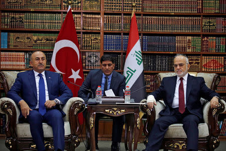 Turkish foreign minister Mevlut Cavusoglu (L) meets with Iraqi Foreign Minister Ibrahim al-Jaafari in Baghdad, Iraq August 23, 2017. REUTERS/Khalid al Mousily