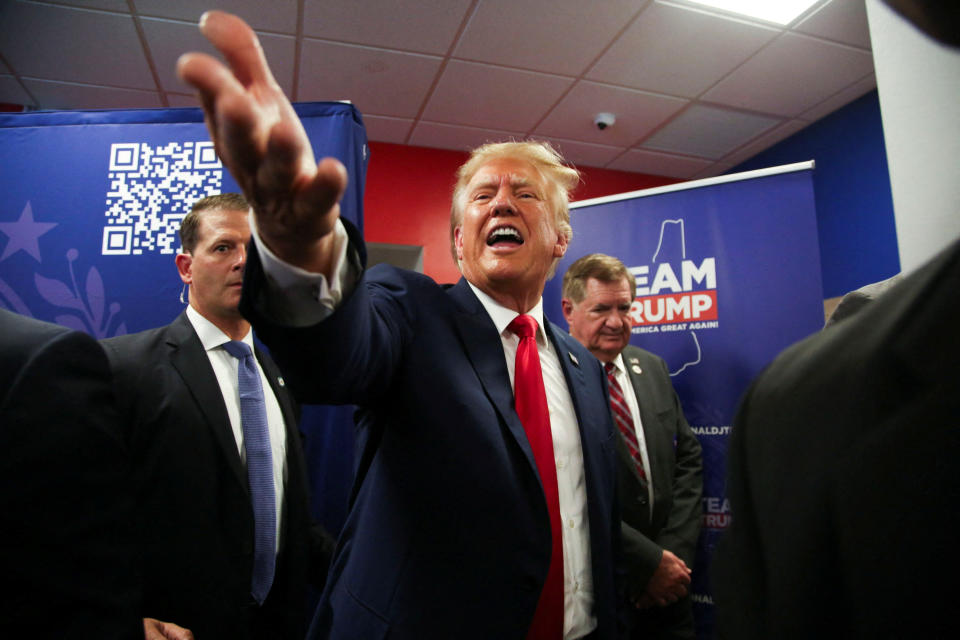 Former U.S. President and Republican presidential candidate Donald Trump greets the crowd during the opening of his campaign headquaters in Manchester, New Hampshire, U.S., June 27, 2023.   REUTERS/Reba Saldanha