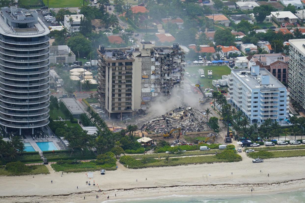 In this Friday, June 25 photo, rescue personnel work in the rubble at the Champlain Towers South Condo, in Surfside, Fla. 