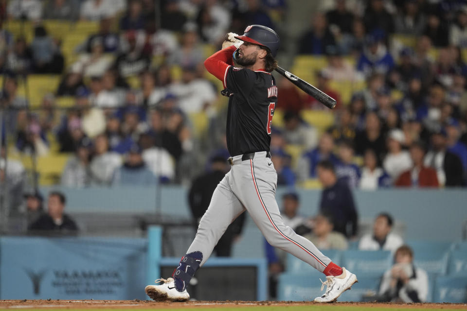 Washington Nationals' Jesse Winker watches his two-run home run against the Los Angeles Dodgers during the third inning of a baseball game Tuesday, April 16, 2024, in Los Angeles. (AP Photo/Marcio Jose Sanchez)