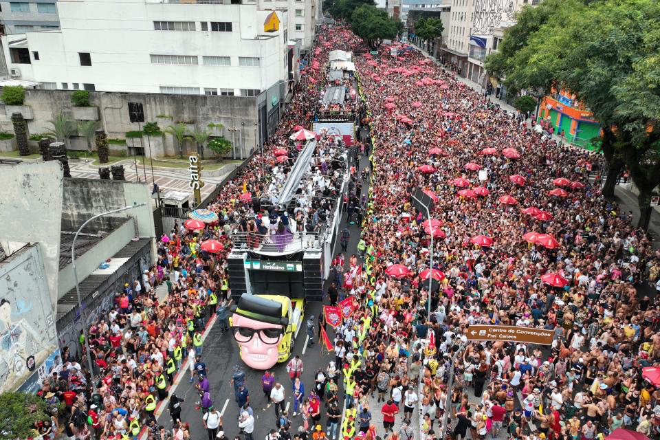 Revelers perform atop the "Trio Eletrico" sound truck as people fill the street during the "Academicos do Baixo Augusta" pre-Carnival street party in Sao Paulo, Brazil, Sunday, Feb. 4, 2024. (AP Photo/Andre Penner)