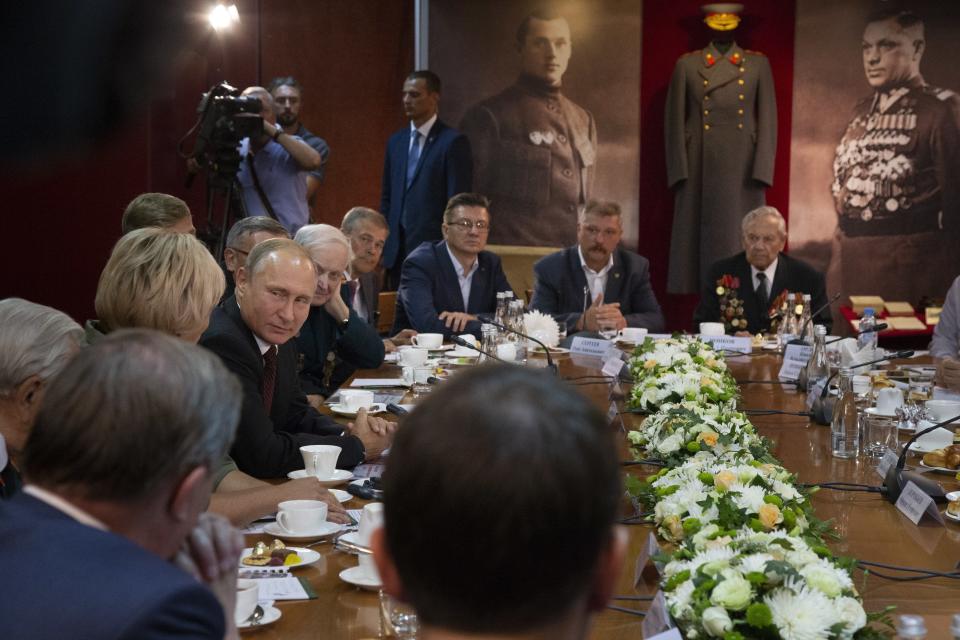 Russian President Vladimir Putin, left, attends a meeting with WWII veterans activists at the Kursk Battle memorial museum in Kursk, 426 kilometers (266 miles) south of Moscow, Russia, Thursday, Aug. 23, 2018. Putin attended a ceremony marking the 75th anniversary of the battle of Kursk in which the Soviet army routed Nazi troops. It is described by historians as the largest tank battle in history involving thousands of tanks. (AP Photo/Alexander Zemlianichenko, Pool)