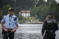 Police officers guard the waterfront as youth activists return to Utoya island, four years on from the deadly attack on a youth summer camp, on August 7, 2015