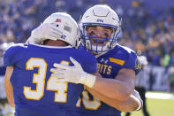 CORRECTS TO NORTH DAKOTA STATE NOT NORTH DAKOTA - South Dakota State fullback Michael Morgan (34) is hugged by teammate Jaxon Janke (10) after scoring a touchdown during the first half of the FCS Championship NCAA college football game against North Dakota State, Sunday, Jan. 8, 2023, in Frisco, Texas. (AP Photo/LM Otero)