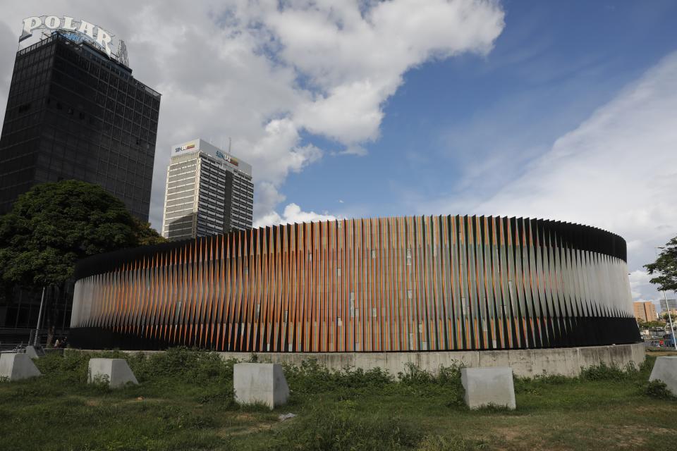 The masterpiece Fisicromía Concavo-Convexa, by Venezuela's master of kinetic art Carlos Cruz-Diez, stands in Caracas' Plaza Venezuela, Venezuela, Tuesday, July 30, 2019. As the art world mourns the death of Cruz-Diez, in his home country many of his urban works are deteriorating and disintegrating, even as the government pays lip service to his art. (AP Photo/Ariana Cubillos)