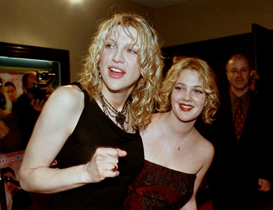 Actress Drew Barrymore, (R) star of the new romantic comedy film "Home Fries," poses with actress and singer Courtney Love at the film's premiere November 16 in Los Angeles. Love was a guest at the premiere.