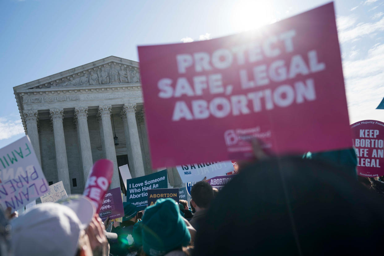 People participate in an abortion rights rally outside of the Supreme Court on March 4