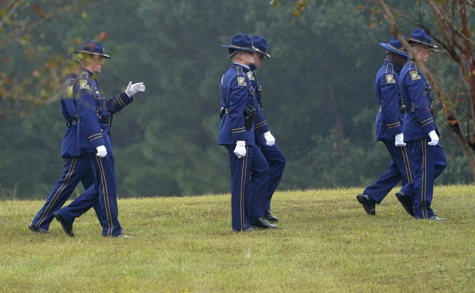 Members of a Louisiana State Police honor guard conclude their practice of folding an American flag to be presented to the family of Master Trooper Chris Hollingsworth during burial services, Friday, Sept. 25, 2020, in West Monroe, La. Hollingsworth, killed in a car crash hours after he was told he would be fired for his role in the death of a Black man, was buried with honors Friday at a ceremony that authorities sought to keep secret out of concerns it would attract a mass protest. (AP Photo/Rogelio V. Solis)