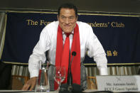 CORRECTS TO 1976, NOT 1979 - FILE - Japanese pro-wrestler-turned-politician Kanji "Antonio" Inoki bows at the end of a news conference at the Foreign Correspondents' Club of Japan in Tokyo on Aug. 21, 2014. A popular Japanese professional wrestler and lawmaker Antonio Inoki, who faced a world boxing champion Muhammad Ali in a mixed martial arts match in 1976, has died at 79. The New Japan Pro-Wrestling Co. says Inoki, who was battling an illness, died earlier Saturday, Oct. 1, 2022. (AP Photo/Eugene Hoshiko, File)