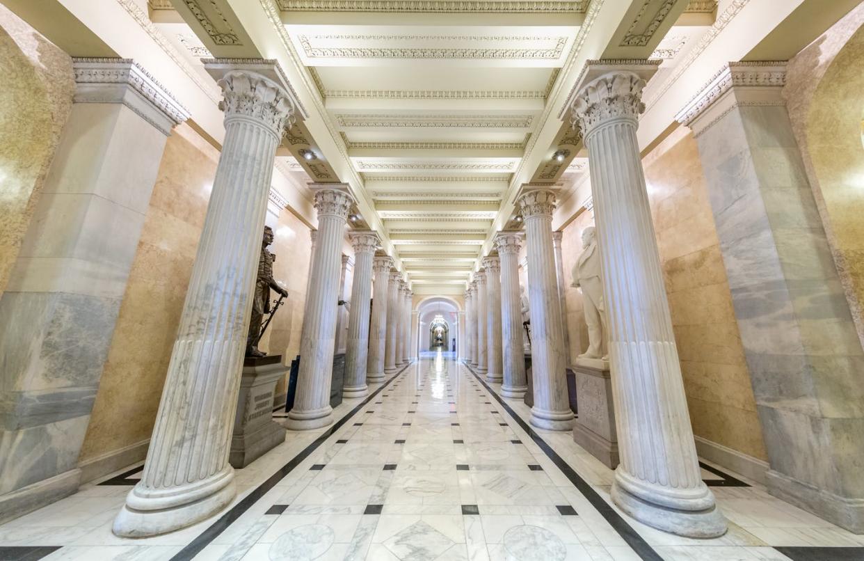 <span class="caption">Bills have a long journey that includes going through the parliamentarian's office in the Senate. Here, a corridor in the Senate.</span> <span class="attribution"><a class="link " href="https://www.gettyimages.com/detail/photo/capitol-building-senate-corridor-in-washington-dc-royalty-free-image/889108426?adppopup=true" rel="nofollow noopener" target="_blank" data-ylk="slk:dkfielding/iStock/Getty Images Plus;elm:context_link;itc:0;sec:content-canvas">dkfielding/iStock/Getty Images Plus</a></span>