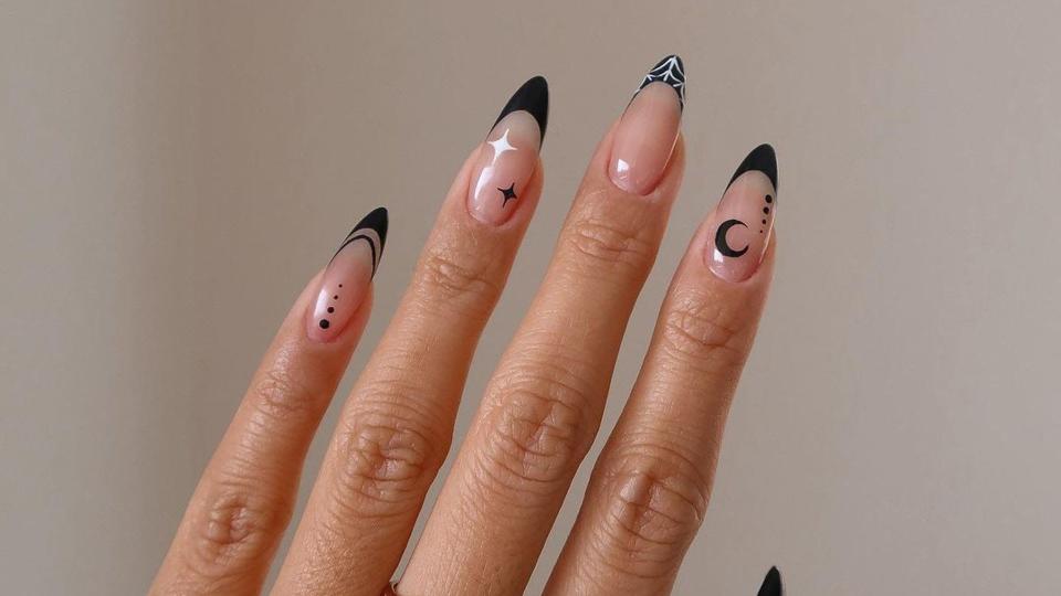 Nails with black tips and moon and stars art