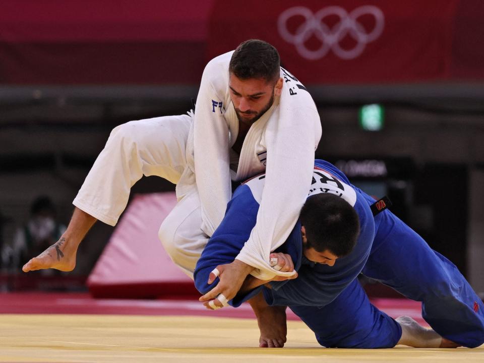 Israel's Peter Paltchik (white) and Russia's Tamerlan Bashaev compete in the judo mixed team's bronze medal B bout during the Tokyo 2020 Olympic Games at the Nippon Budokan in Tokyo