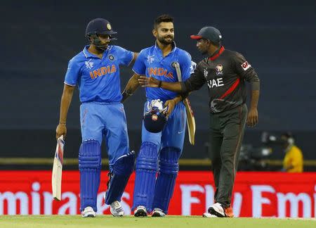 India's batsmen Rohit Sharma (L) and Virat Kohli are congratulated by United Arab Emirates' Andri Raffaelo after India won their Cricket World Cup match in Perth, February 28, 2015. REUTERS/David Gray