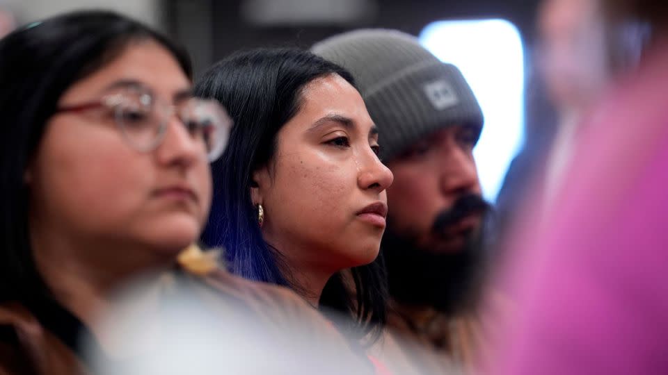 Kimberly Mata-Rubio, center, and other family members of the Uvalde shooting victims listen to US Justice Department officials during Thursday's news conference. - Eric Gay/AP