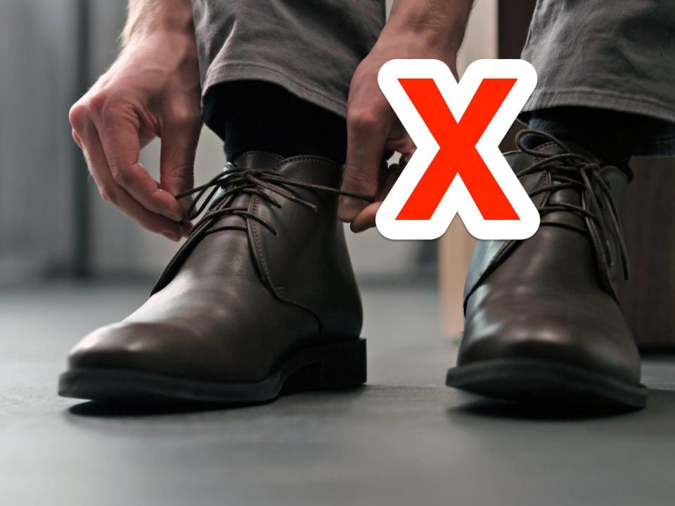 red x next to someone tying a pair of brown chukka boots