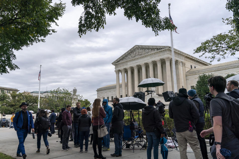 People gather as the Supreme Court begins its new term and to hear the first arguments, on Capitol Hill in Washington, Monday, Oct. 3, 2022. Monday's session is also the first time new Justice Ketanji Brown Jackson, the court's first Black female justice, will participate. And it's the first time the public will be able to attend since the court closed in March 2020 because of the coronavirus pandemic. (AP Photo/J. Scott Applewhite)